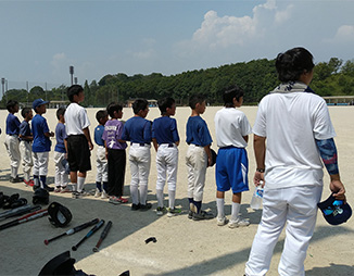 入居者たちが屋外でスポーツ活動に参加している様子。野球やソフトボールなどの運動レク。